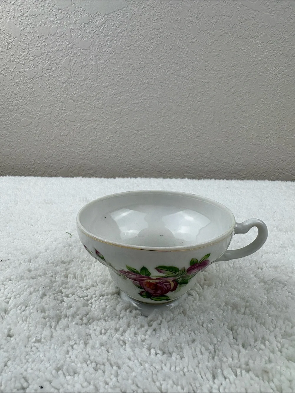 Vintage Porcelain Teacup & Saucer Set Featuring Pink Roses on a White Background